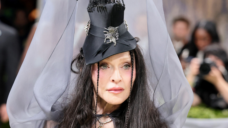 Madonna posing at the Met Gala with long, black hair