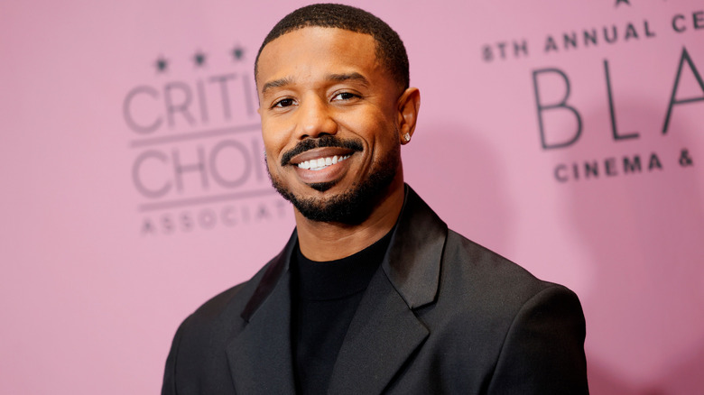 image of Michael B. Jordan smiling and looking at the camera on the red carpet of an event