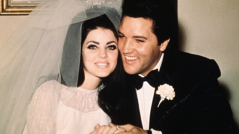 Priscilla Presley and Elvis Presley at their wedding
