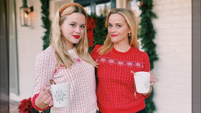 Reese Witherspoon and daughter Ava Phillippe smile while holding mugs in this photo posted in December 2020