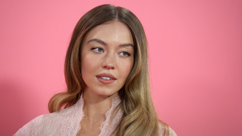 Sydney Sweeney in a pink shirt