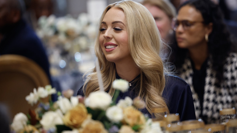 Tiffany Trump smiling while sitting at an event