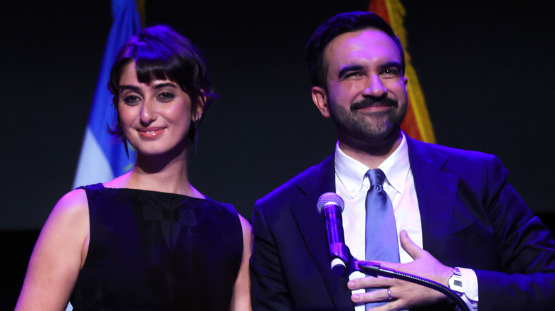 Rama Duwaji and Zohran Mamdani smiling on stage.