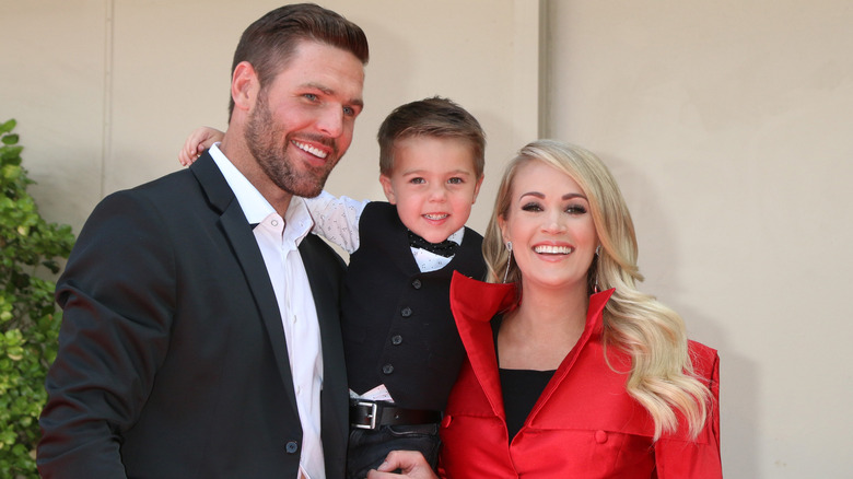 Carrie Underwood and Mike Fisher with their son Isaiah at Underwood's Hollywood Walk of Fame ceremony in September 2018