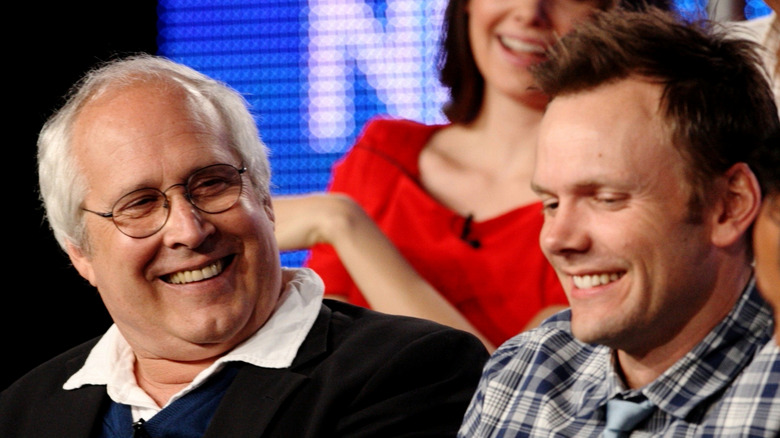 Chevy Chase looking at an uncomfortable Joel McHale during a press event for the sitcom Community