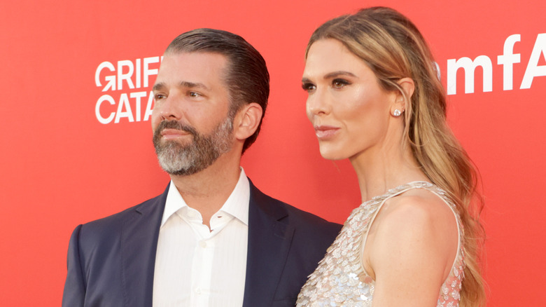 Donald Trump Jr. and Bettina Anderson looking serious while posing for the cameras
