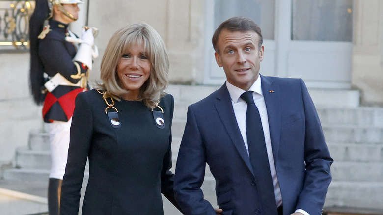 Emmanuel Macron and Brigitte Macron posing for a photograph
