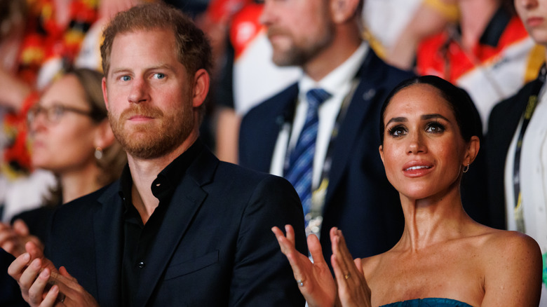 Prince Harry and Meghan Markle clap during Invictus Games