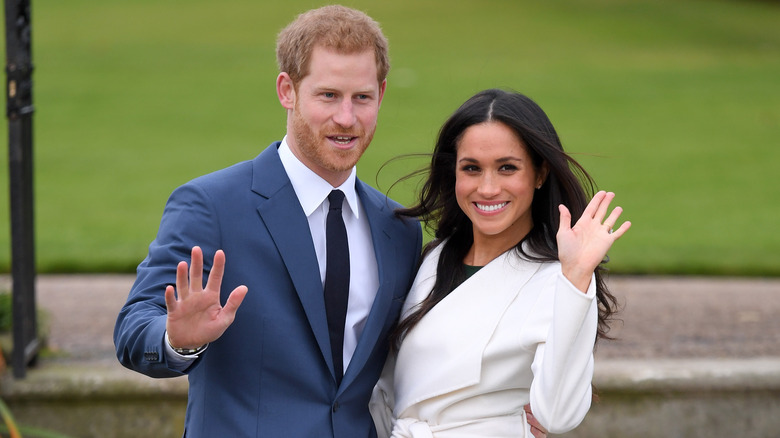 Prince Harry and Meghan Markle waving 