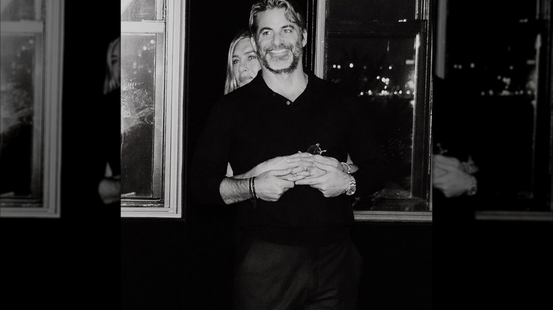 Black and white photo of Jennifer Aniston and Jim Curtis embracing