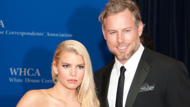 Jessica Simpson with a straight face and Eric Johnson smiling at an Association Dinner