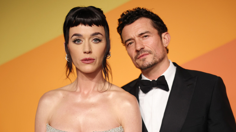 Katy Perry and Orlando Bloom posing for photos in their finery