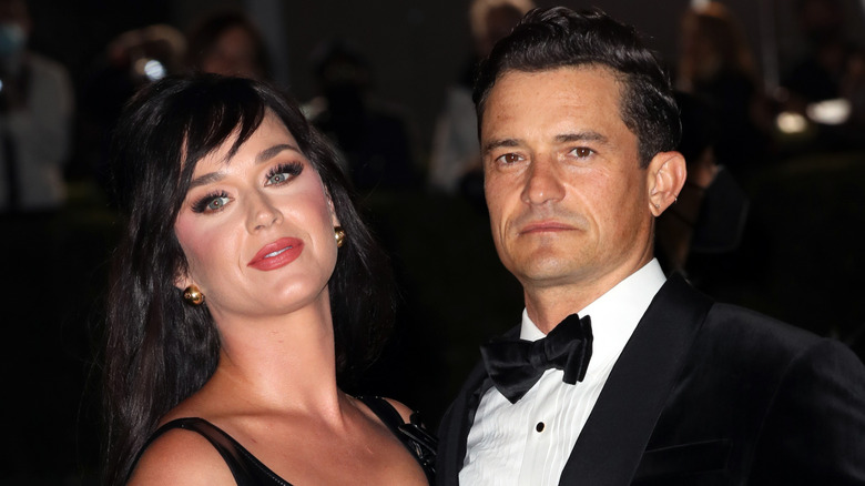 Katy Perry and Orlando Bloom posing for photos in their finery