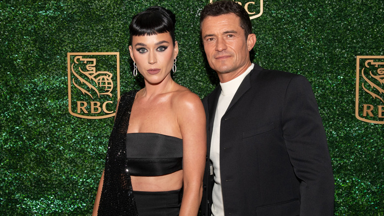 Katy Perry and Orlando Bloom posing for photos at an event