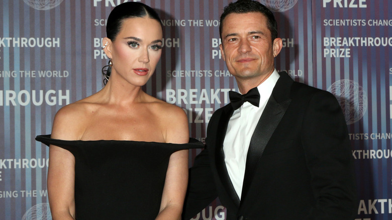 Orlando Bloom and Katy Perry posing for photos all in black