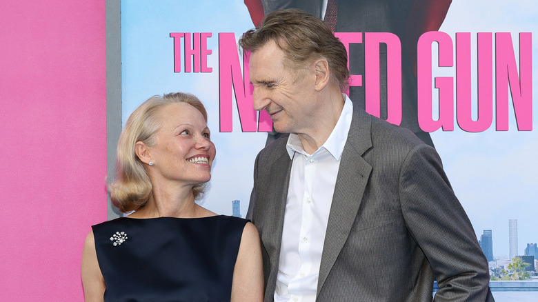 Pamela Anderson and Liam Neeson look lovingly at each other at a Naked Gun event