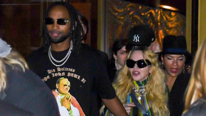 Madonna and Akeem Morris walking out of a building