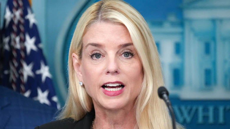 Pam Bondi speaking in a black blazer while at a press conference.