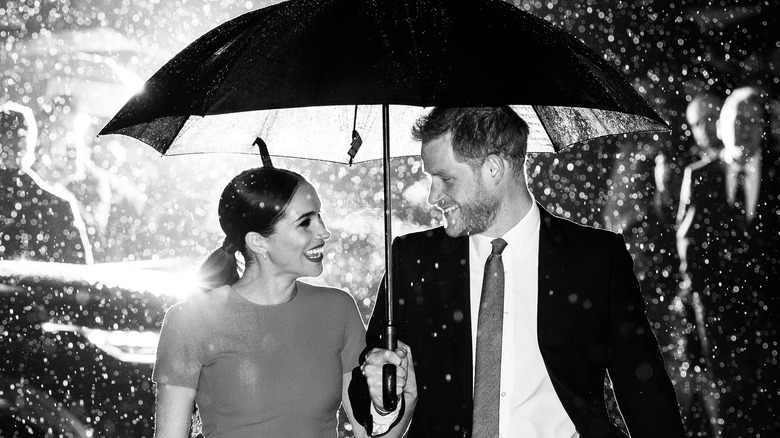 Meghan Markle Prince Harry under umbrella 