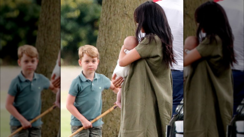 A young Prince George looking at an infant Prince Archie.