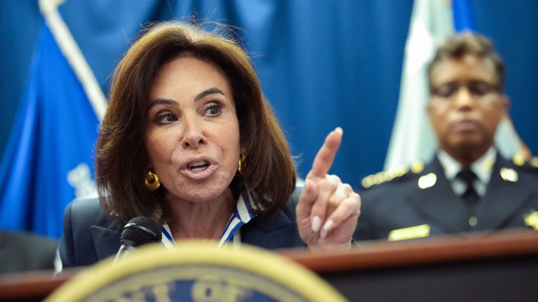 Jeanine Pirro pointing and talking behind a podium.