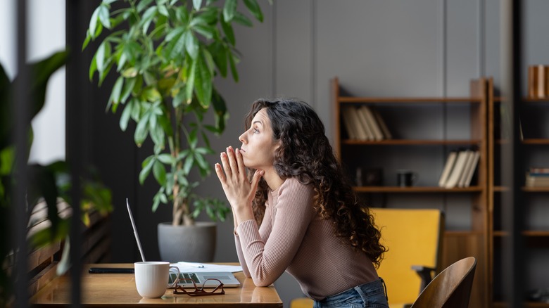 Woman looking tired at desk