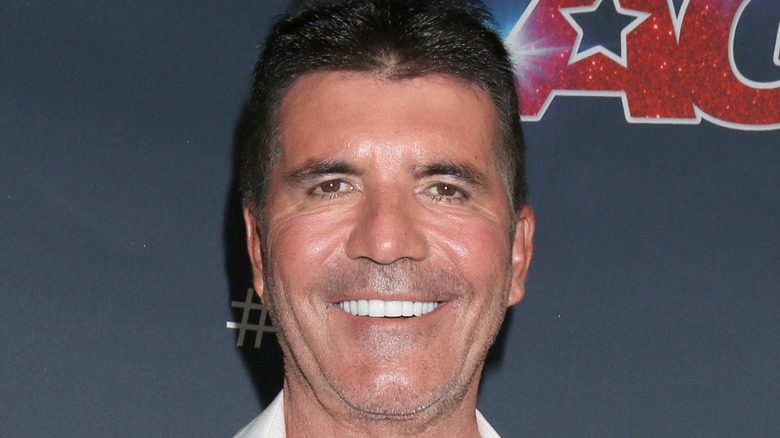 Simon Cowell smiling on an "America's Got Talent" red carpet