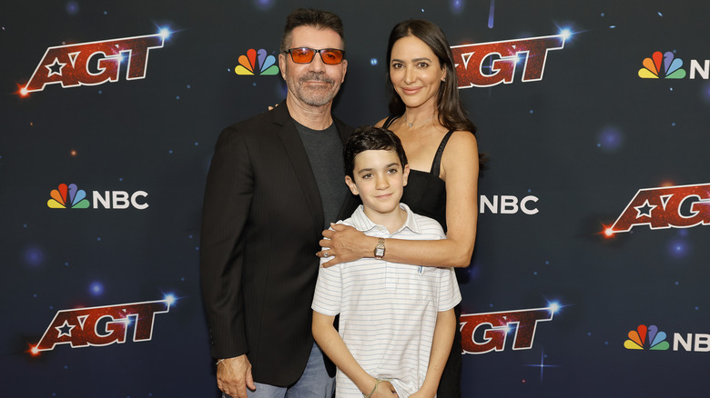 Simon Cowell, Eric Cowell, and Lauren Silverman smile together