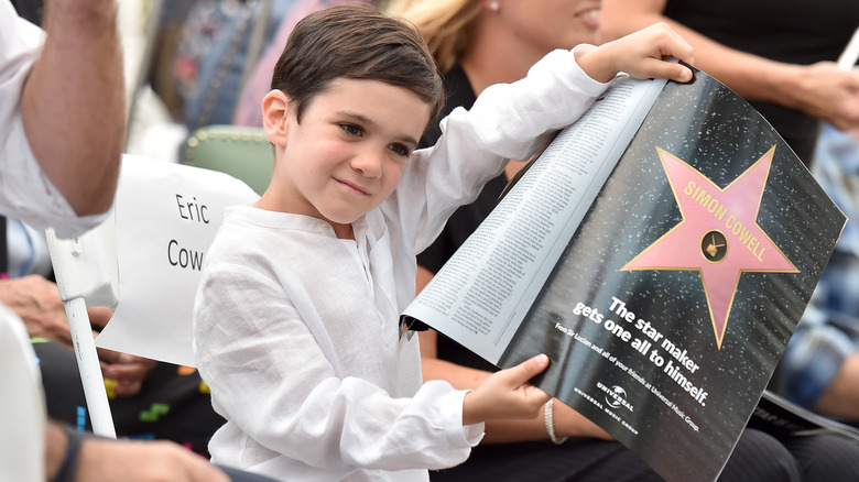 Eric Cowell holding up a magazine 