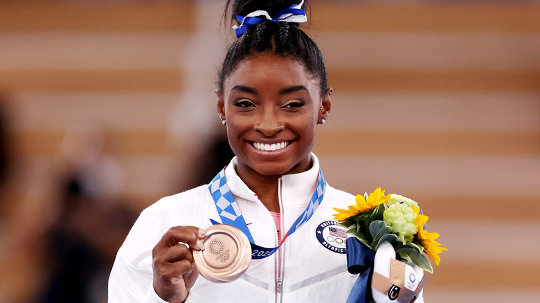 Simone Biles with her Olympic medal