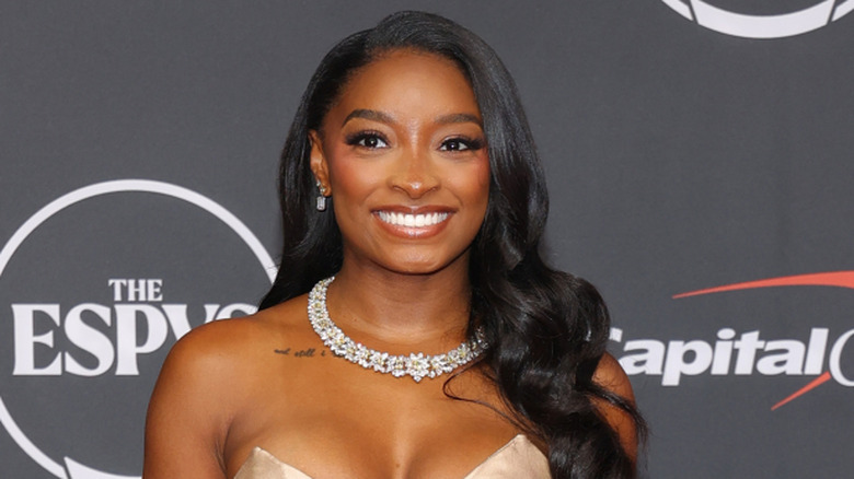 Simone Biles at the Espys smiling and wearing a diamond necklace