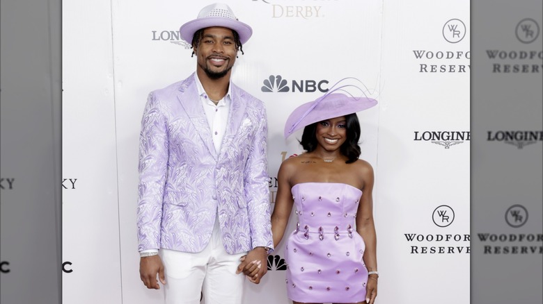 Jonathan Owens and Simone Biles holding hands on the red carpet at The Kentucky Derby