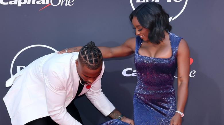 Jonathan Owens helping Simone Biles fix her dress at the ESPYS