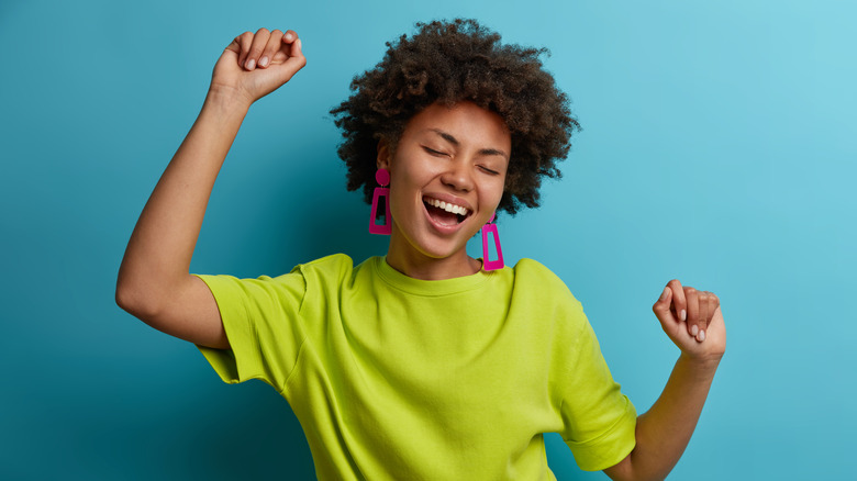 Energetic woman dancing and smiling