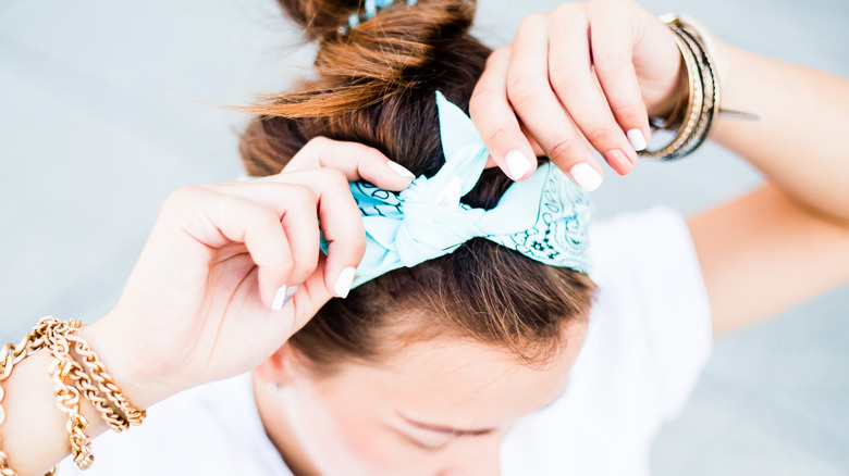 A woman in wearing a scarf around her hair