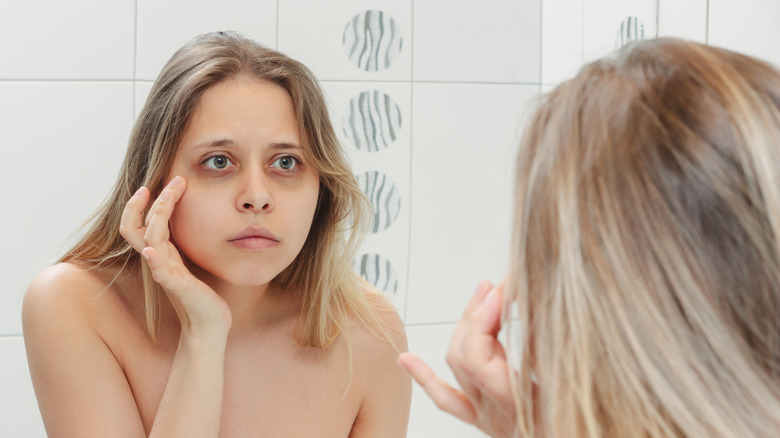 Woman looking in mirror