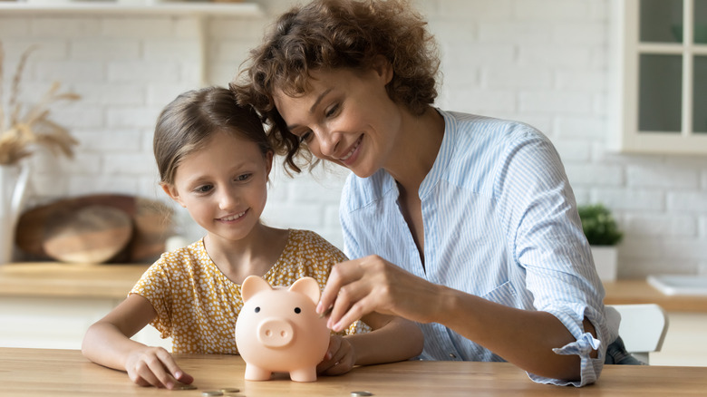 Mother and child saving money