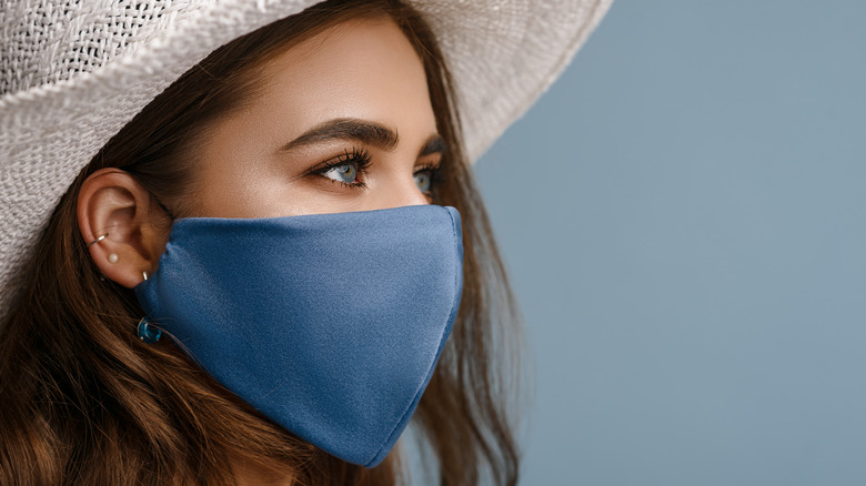 Woman wearing hat and face mask