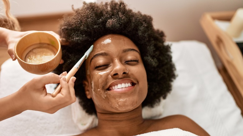 woman smiling getting facial 