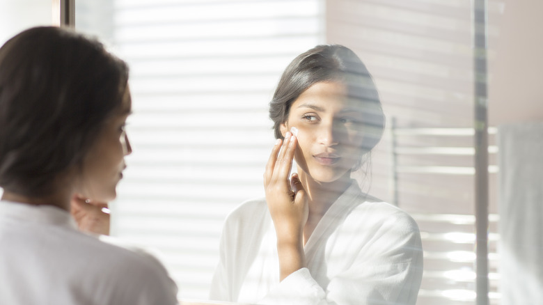 Woman using skincare at home