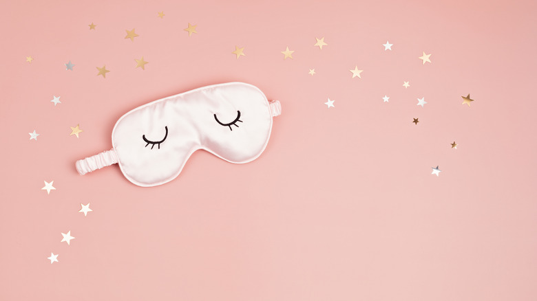 Sleeping mask on starry background