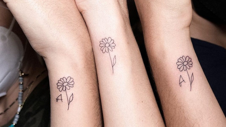 matching daisy wrist tattoos