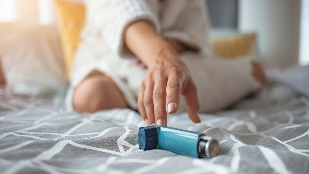 Woman reaching for inhaler