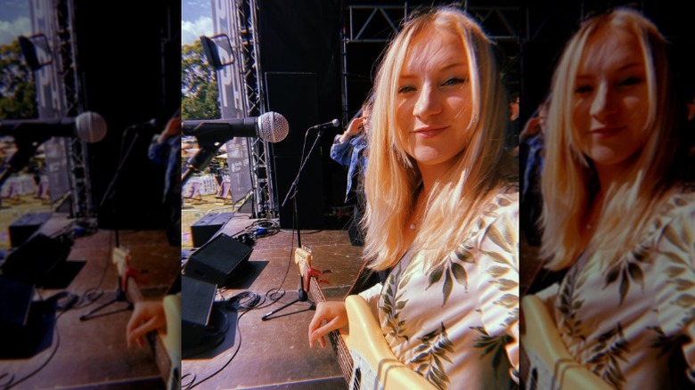 Singer Dolly Mavies takes a selfie onstage with her band