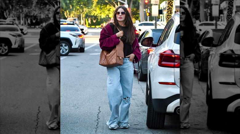 Sofía Vergara on a street in Los Angeles in 2026 wearing a black t-shirt, relaxed blue jeans, and a red hoodie