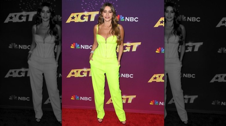 Sofía Vergara on the red carpet for the 2024 America's Got Talent quarterfinals episode, wearing a neon green jumpsuit with cami top and silver open-toed heels