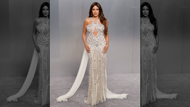 Sofía Vergara at the 2026 Vanity Fair Oscar Party wearing a silver dress embellished with jewel embroidery and a white train