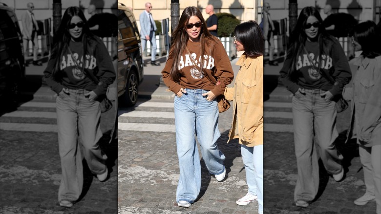 Sofía Vergara in Paris in March 2026 wearing brown sweatshirt and blue jeans with white sneakers and black sunglasses
