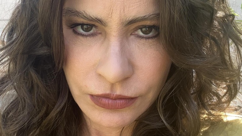 Closup of Vergara with prosthetic nose and caky makeup on the Griselda set