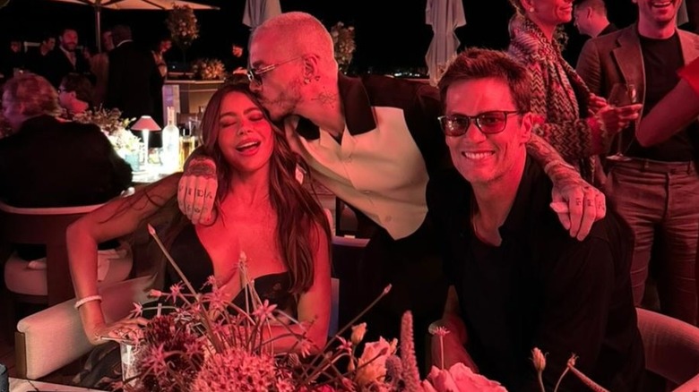 Sofia Vergara posing for a photo with J Balvin and Tom Brady